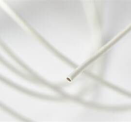 view of micro-miniature coaxial cable in white tubing.