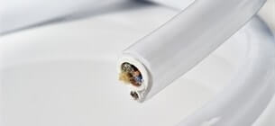 close up view of end of medical cable cut neatly against a white background