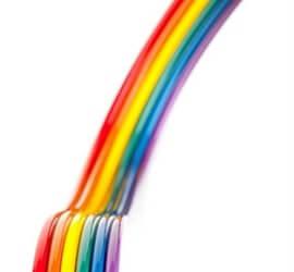 view of rainbow coloured bonded ribbon cable on a white background.